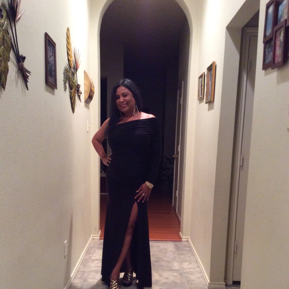 Black off the shoulder dress with high side slit.